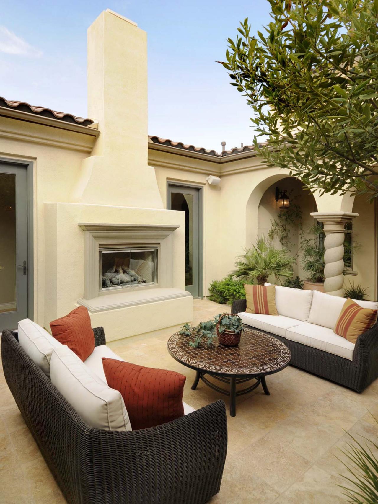 Modern Outdoor Stucco Fireplace with Beautiful Sleek Sofas 