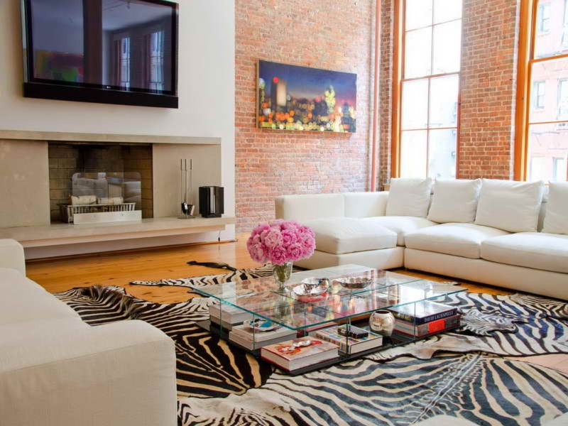 Living Room Using Extra Large Cowhide Rug Also Modern Glass Table