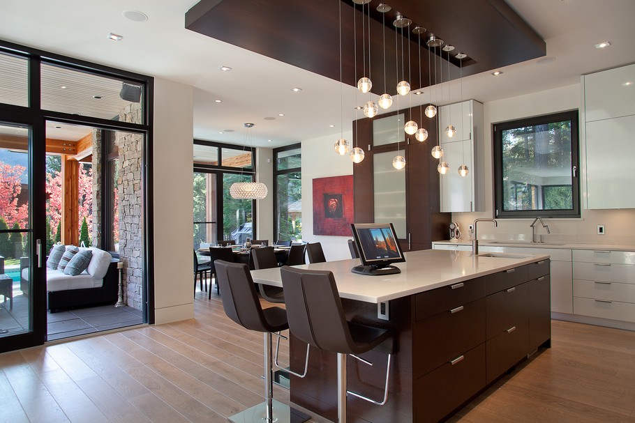 Kitchen with Wooden Island and Brown Stools under the Bubble Lamps