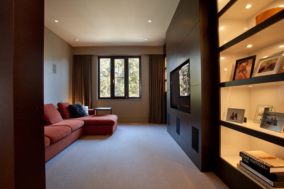 Long Red Chaise and Dark Shelves under White Ceiling