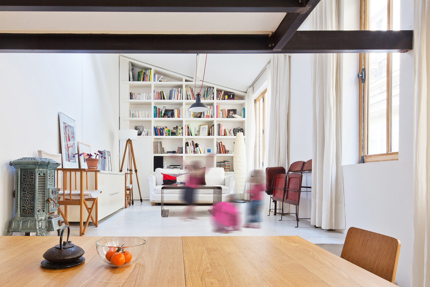 Sofa Sleek Marble Floor Dark Metallic Pendant Light Wood Dining Table Transformation of a Studio into a Loft