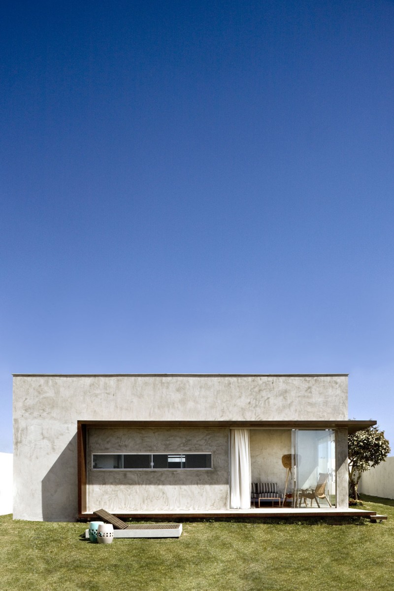 Wide Glass Walls and Concrete Wall under Flat Roof with Sliding Glass Doors