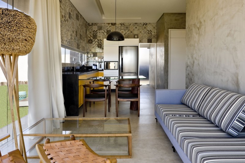 Living Room with Long Sofa and Low Glass Table on Concrete Floor