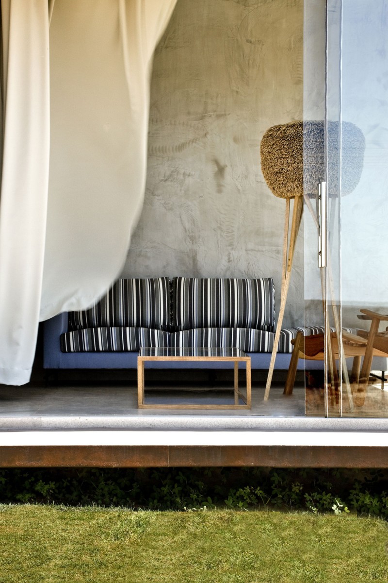 Long Sofa and Unusual Floor Lamp on the Concrete Floor