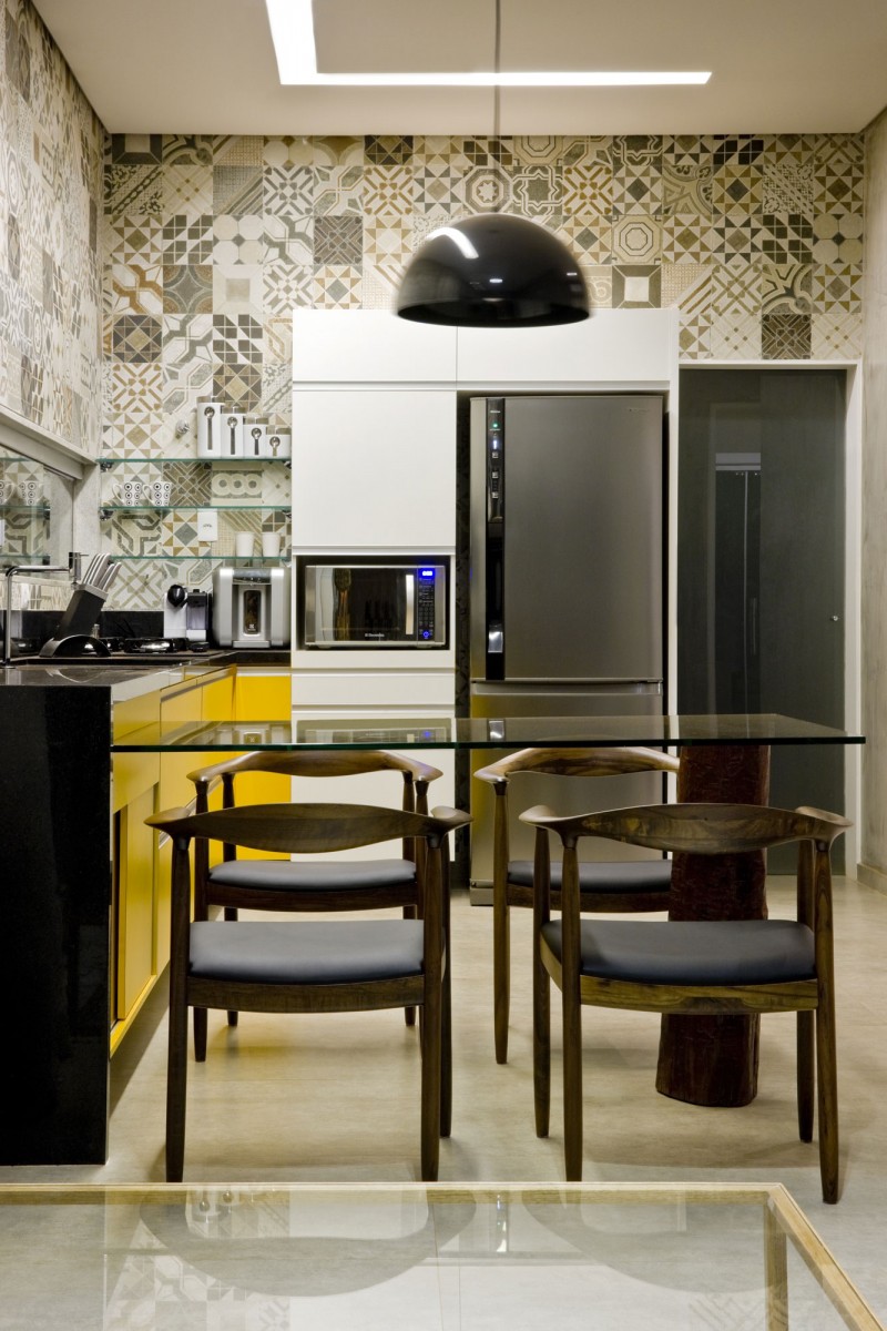 Open Room with Glass Table and Wooden Chairs near the Yellow Cabinets