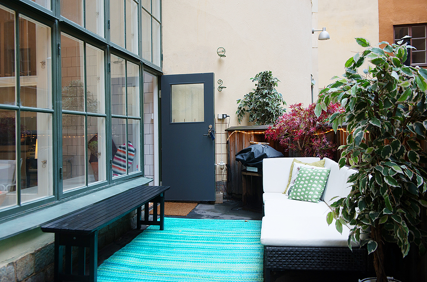 Rattan Chaise and Long Black Bench on Blue Carpet