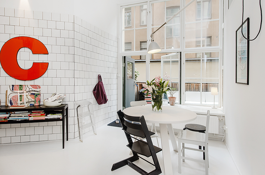 White Rounded Table and White Chairs on White Floor
