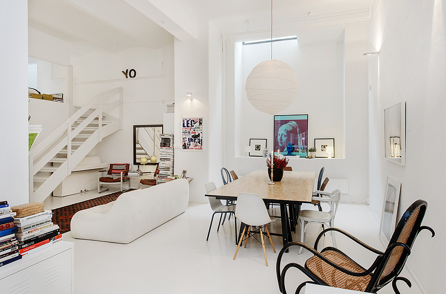 Wooden Table and Unique Chairs under the Wide Rounded Lamp