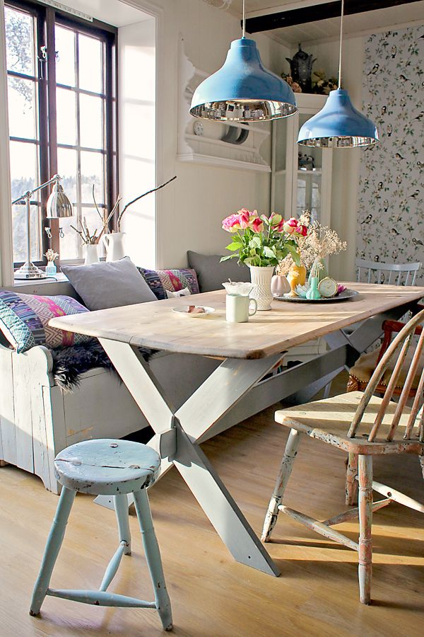 Casual Dining Room with Blue Hanging Lights, Soft Shades and Light Woods