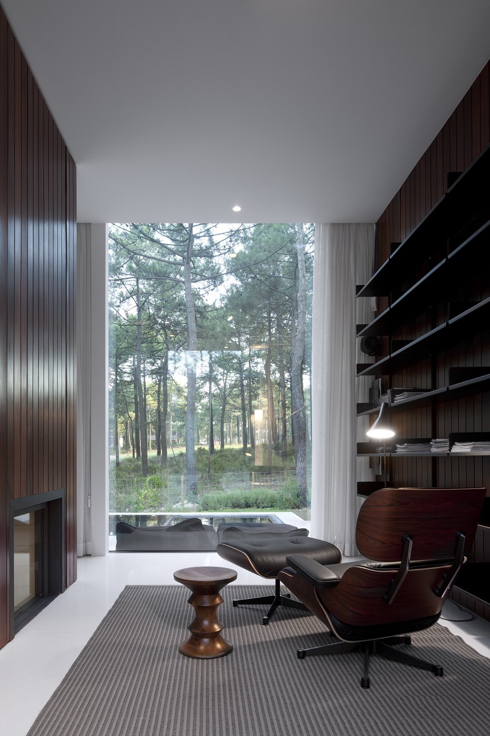Eames Chair Among Foot Rest Also Small Sideboard At Aroeira III House Reading Nook With Floor To Ceiling Glass Window Eames Chair Among Foot Rest Also Small Sideboard At Aroeira III House Reading Nook With Floor To Ceiling Glass Window