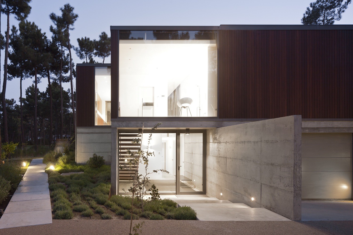 Evening View At Aroeira III House Show Modern Parisian Garden Woth Concrete Pathway Also Glass Entry Door Evening View At Aroeira III House Show Modern Parisian Garden Woth Concrete Pathway Also Glass Entry Door