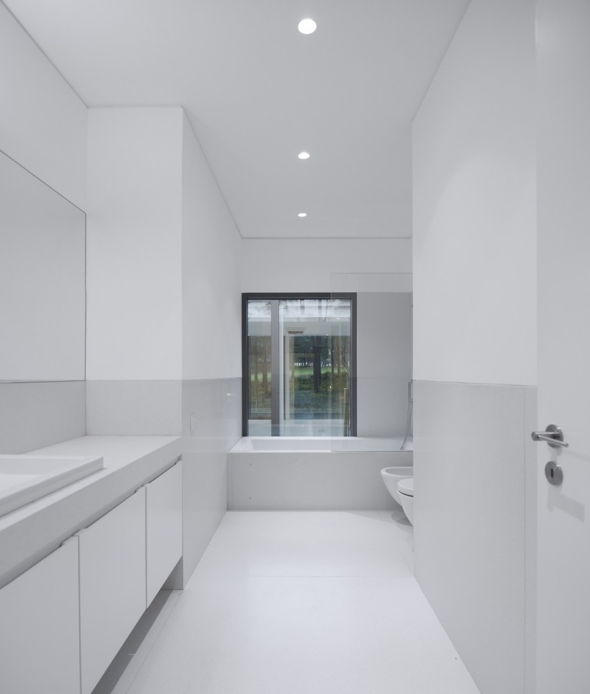 White Bathroom Interior Among Corner Bath Tub Near Window Also Floating Vanity Design under Aroeira III House White Bathroom Interior Among Corner Bath Tub Near Window Also Floating Vanity Design under Aroeira III House