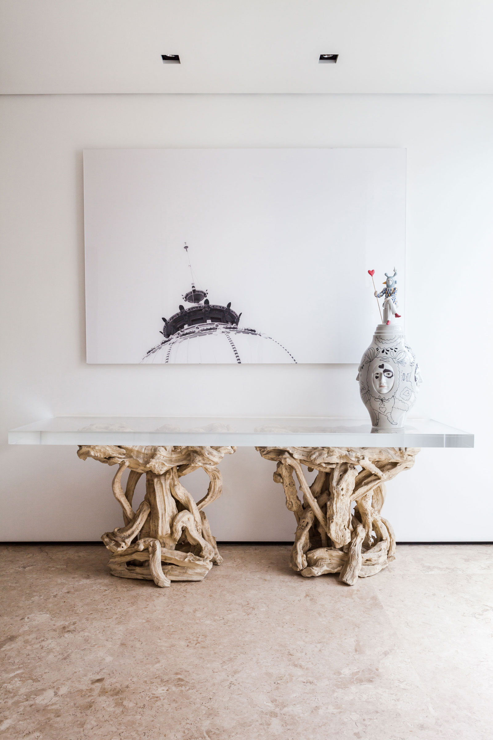 Log Feet Decorated Among Jar Also Artwork Near White Wall