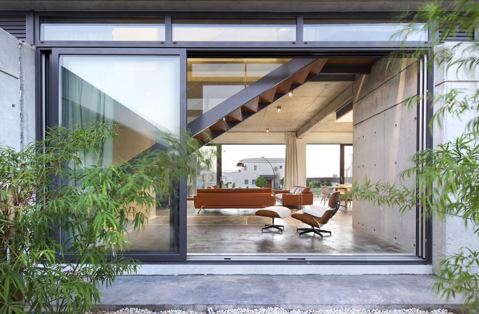 Andri & Yiorgos Residence - Windows From Glass Panels With Black Borders Also Green Plants Garden Andri & Yiorgos Residence - Windows From Glass Panels With Black Borders Also Green Plants Garden