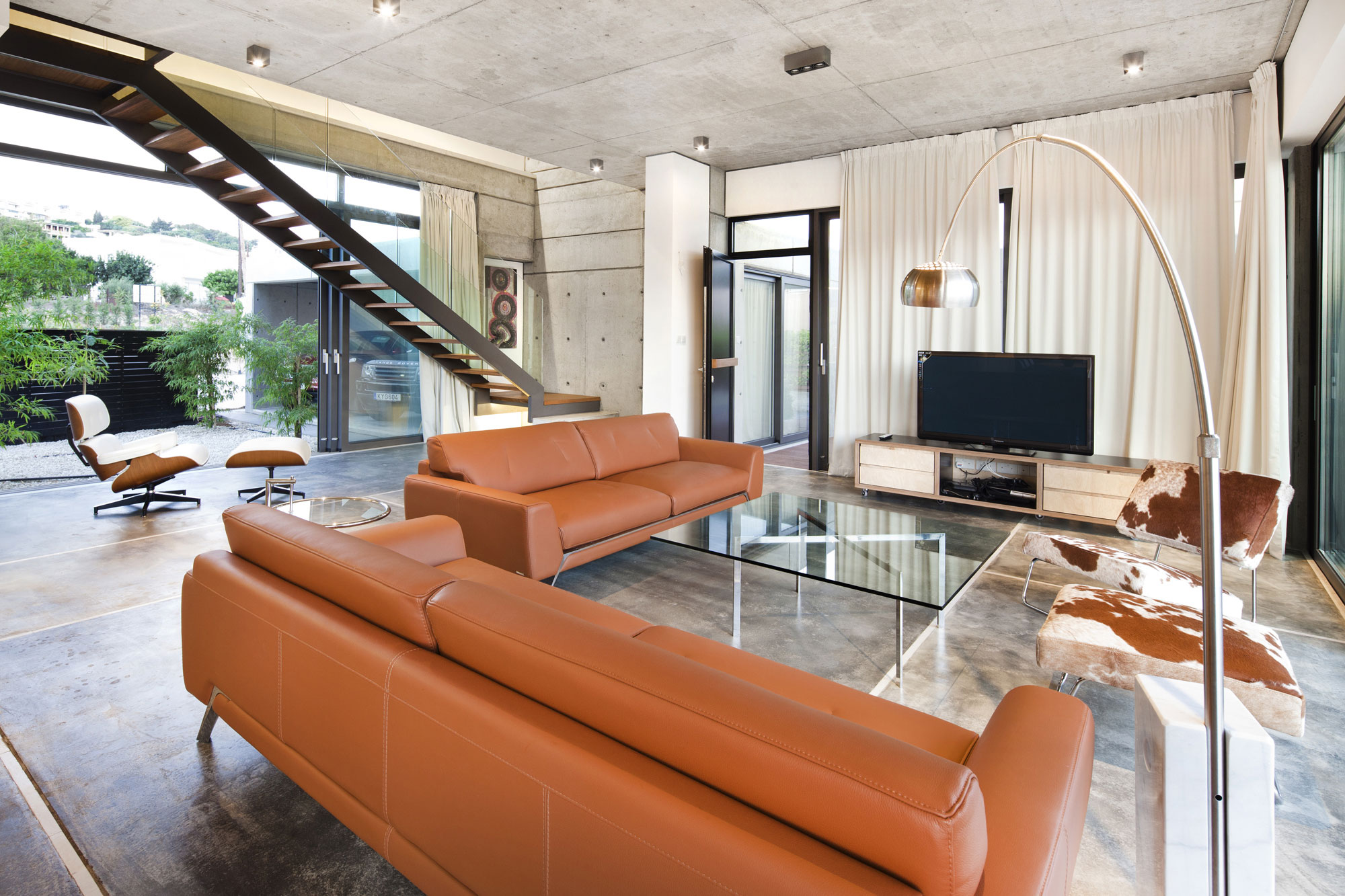 Room Among Brown Sofas Glass Table Also Grey Ceiling Which Is Made From Concrete Room Among Brown Sofas Glass Table Also Grey Ceiling Which Is Made From Concrete