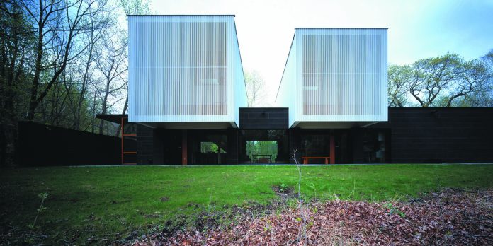 Fresh Green Manicured Lawn Along Near Dried Grasses Growing Surrounding Double Streeter House Building Near Pillars