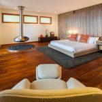 Bedroom Decoration with Colorful Pillows On Clear Bed On Wooden Floor