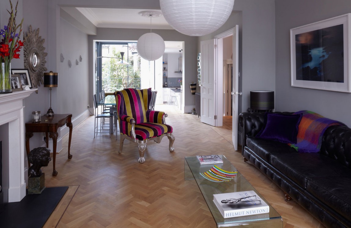 Black Sofas Added Near Colorful Single Lounger On Wooden Board Flooring Black Sofas Added Near Colorful Single Lounger On Wooden Board Flooring