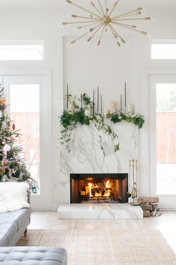 Fireplace with candles greenery mantel idea