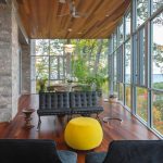 Living Area Including Black Sofa Added Near Yellow Round Table