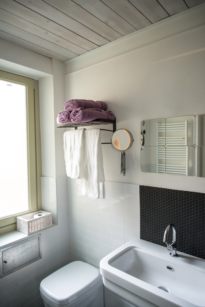 Via delle Orfane by CON3STUDIO - Ceramic Bathtub Added Near Metallic Faucet Also Glass Window On Wall Via delle Orfane by CON3STUDIO - Ceramic Bathtub Added Near Metallic Faucet Also Glass Window On Wall