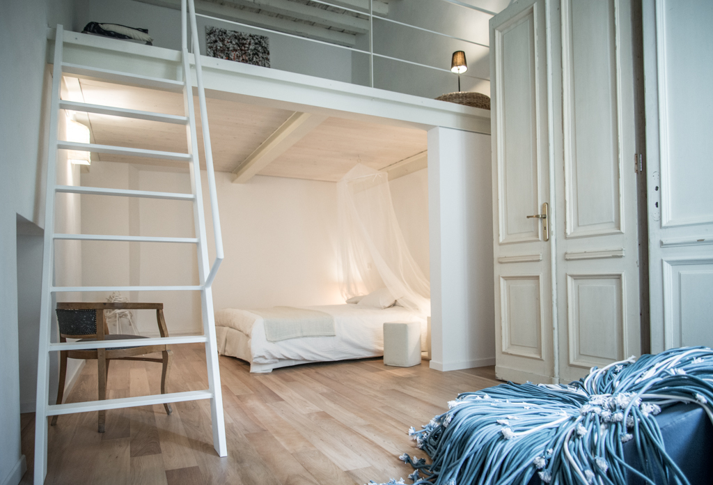 Via delle Orfane by CON3STUDIO - White Bed Added Near A Stair Land On Wooden Floor Also Satnd Wardrobe Via delle Orfane by CON3STUDIO - White Bed Added Near A Stair Land On Wooden Floor Also Satnd Wardrobe