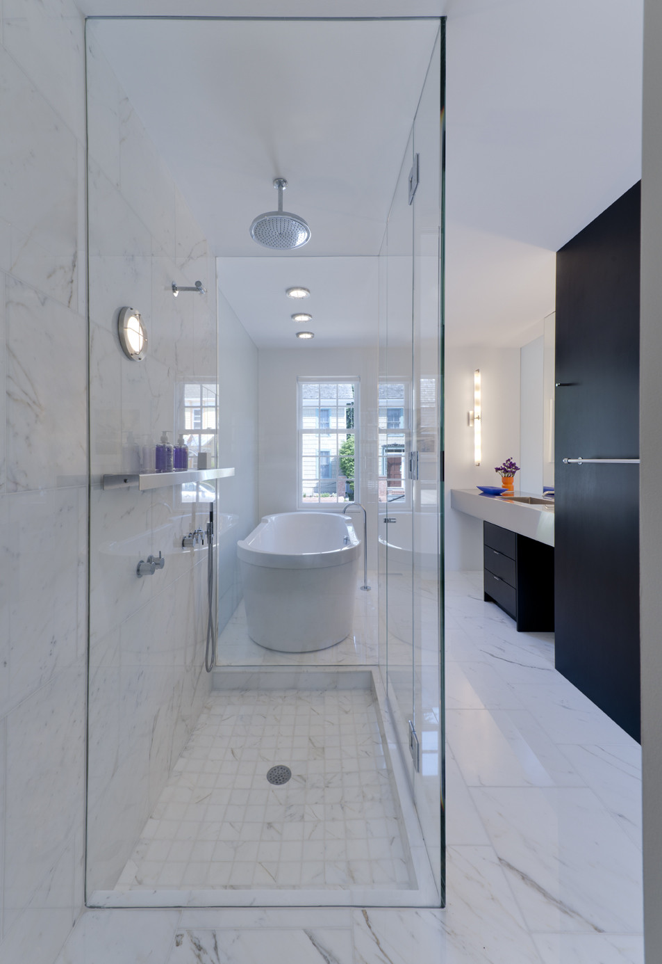 White Colored Bathtub Made From Marble Along With Silver Colored Stainless Ceiling Shower White Colored Bathtub Made From Marble Along With Silver Colored Stainless Ceiling Shower