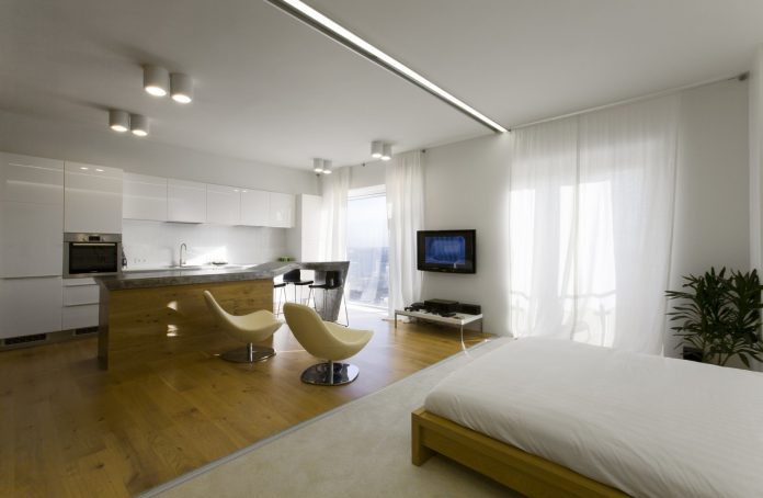 White Colored Floor Carpet Along With Comfy Brown Wooden Floor