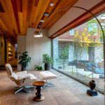 White Lounger Added Near An Arc Lamp On Floor