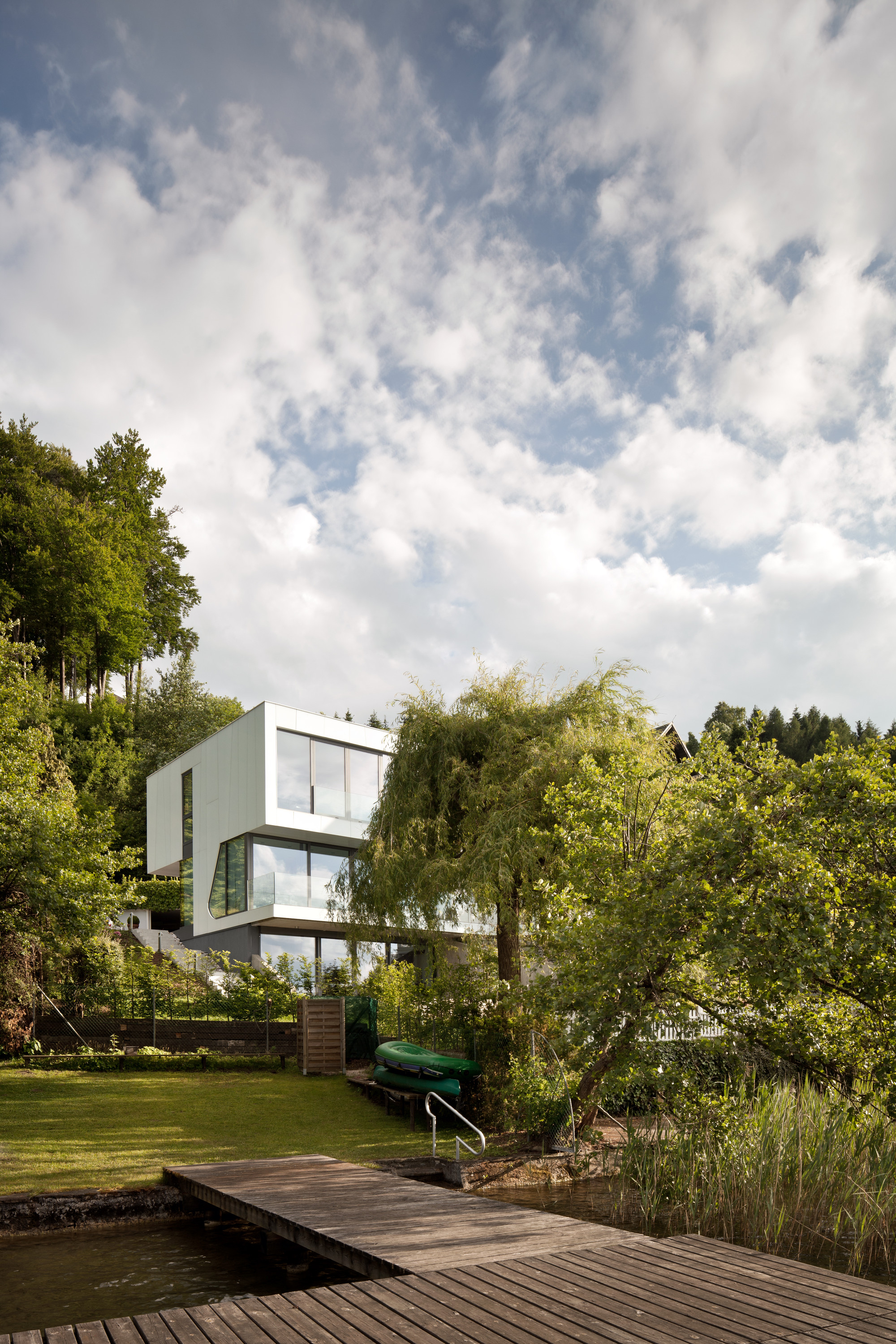 Wooden Deck Along With Water Feature Surrounded Green As Well As Lush Vegetations Wooden Deck Along With Water Feature Surrounded Green As Well As Lush Vegetations