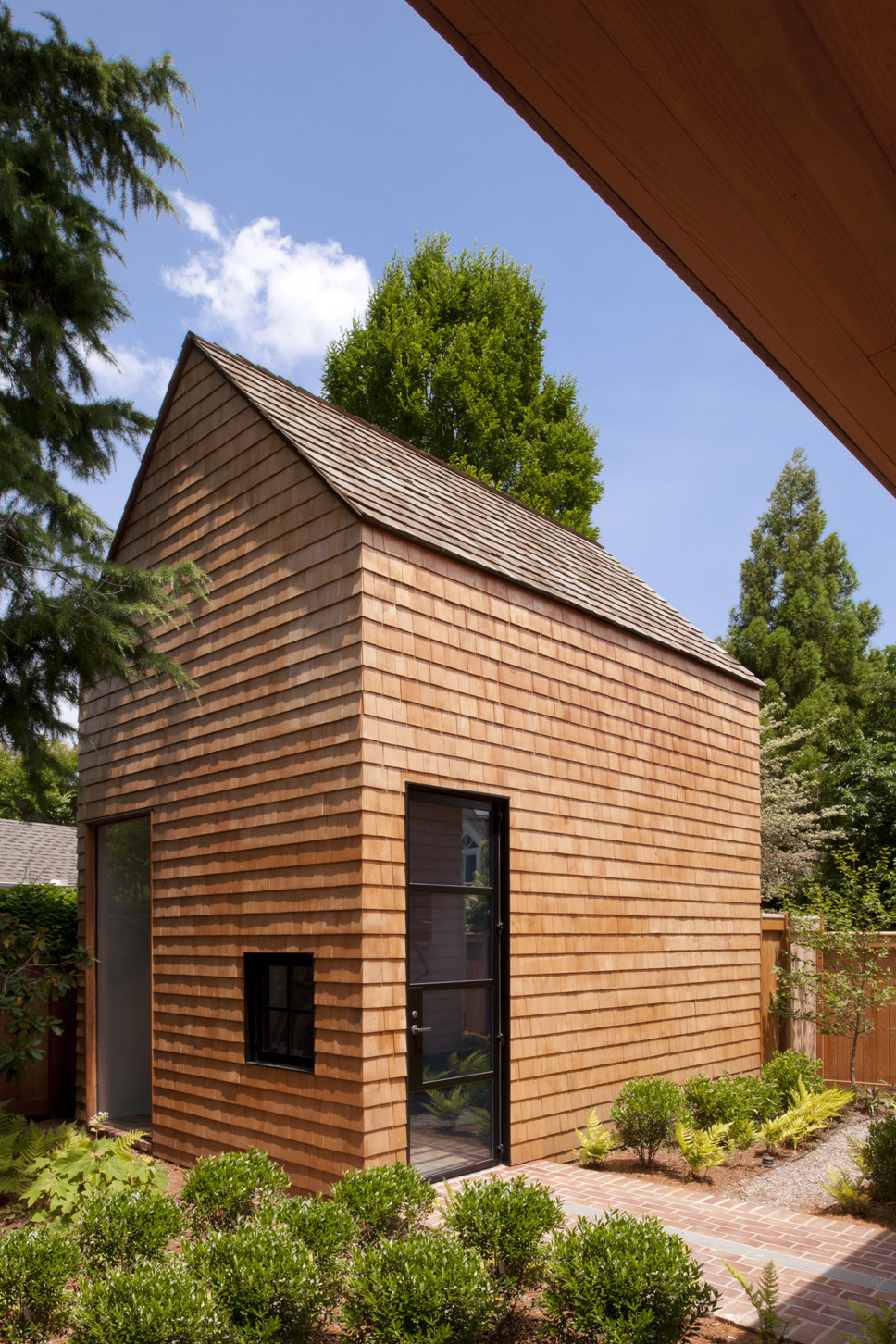 Wooden Outer Wall Along With Transparent Glass Door Which Has Black Metalic Frame Wooden Outer Wall Along With Transparent Glass Door Which Has Black Metalic Frame