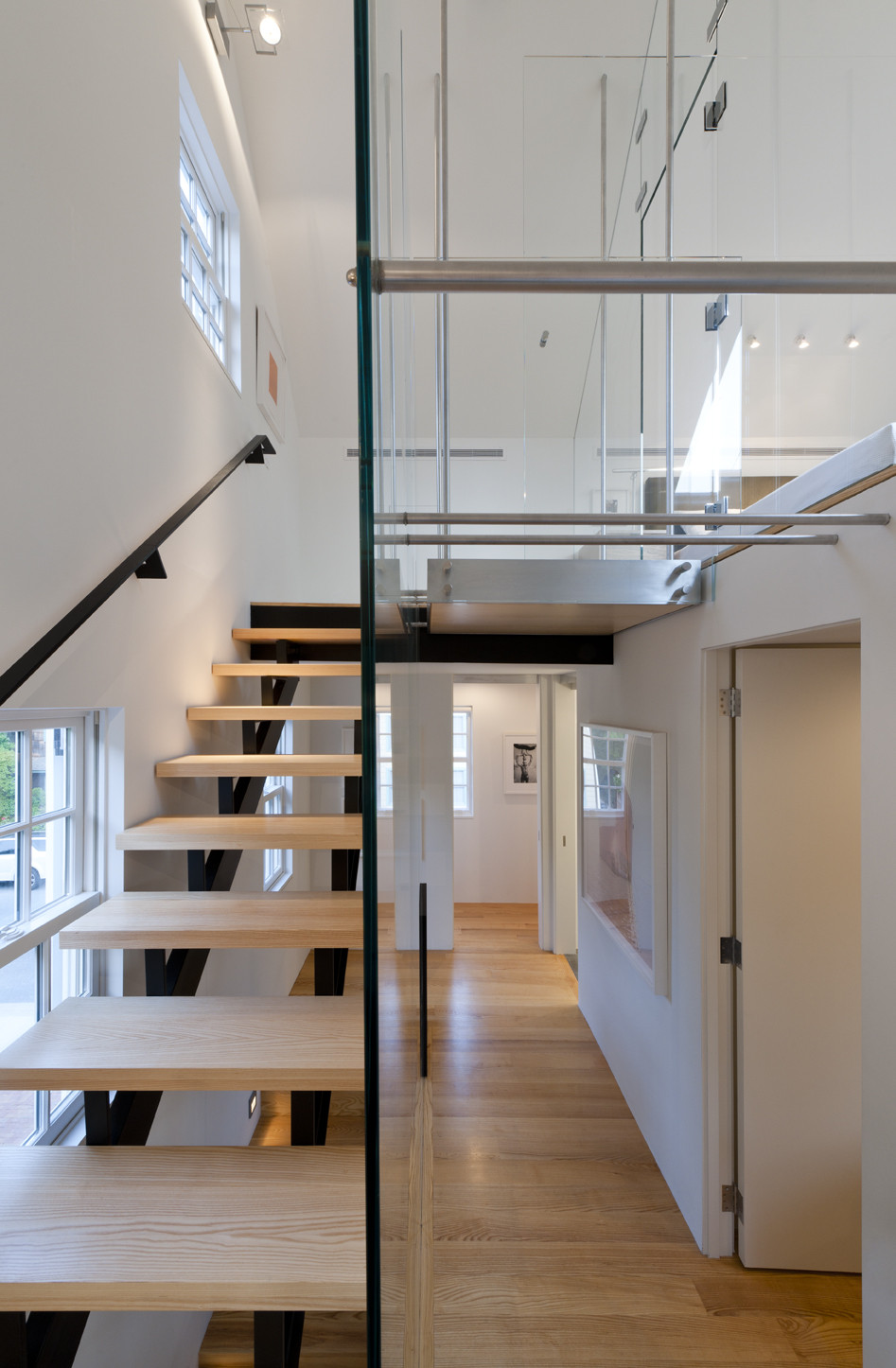 Wooden Staircase Which Has Black Colored Handrail Made From Metallic Material Wooden Staircase Which Has Black Colored Handrail Made From Metallic Material