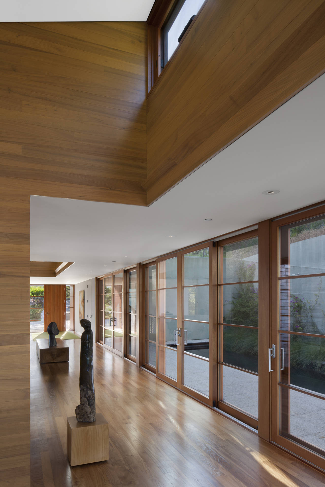 Appealing Hallway At Kentfield House Decorated Near Some Artworks Stand On Wooden Floor Beside Glass Sliding Door Appealing Hallway At Kentfield House Decorated Near Some Artworks Stand On Wooden Floor Beside Glass Sliding Door