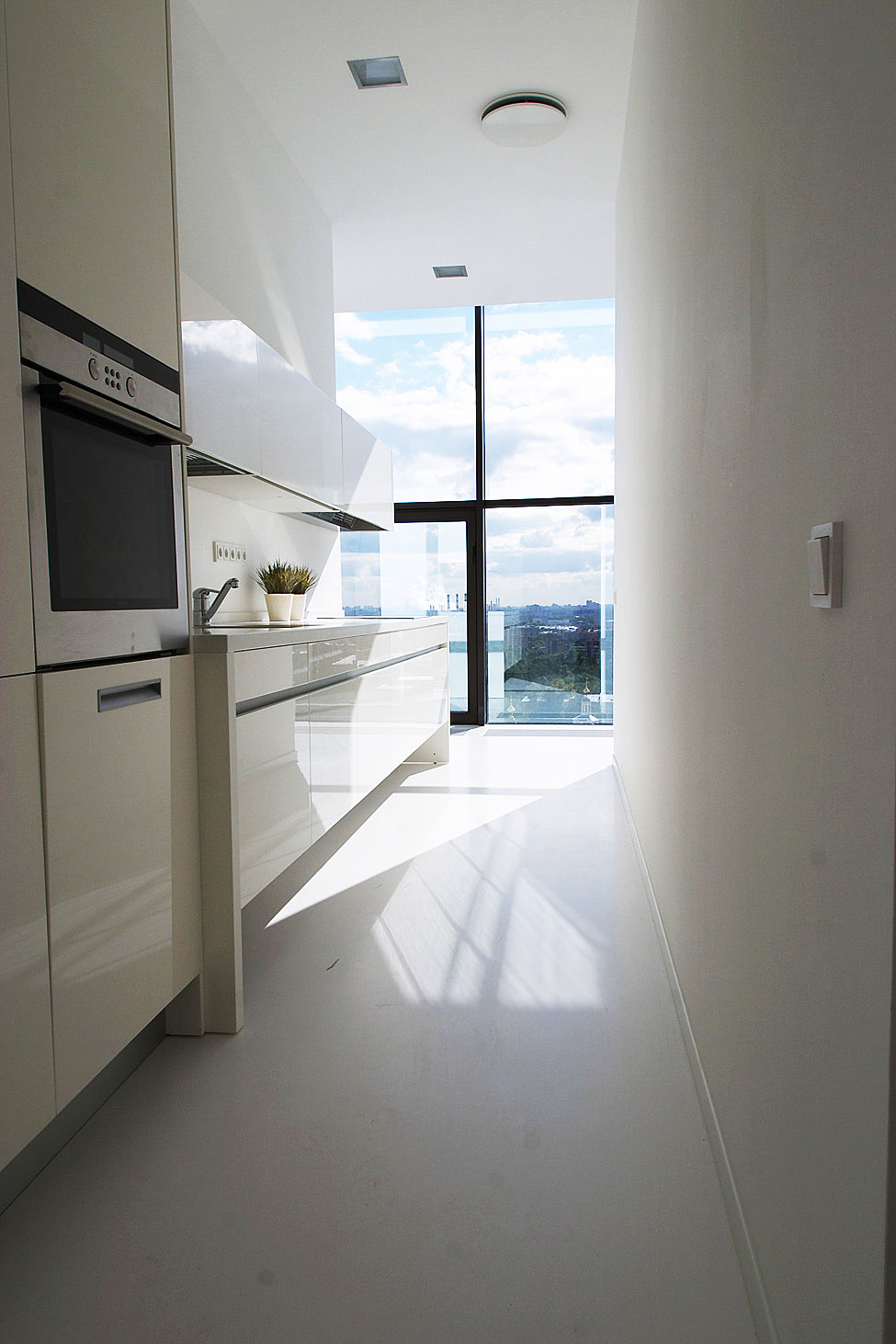 Fabulous Galley Kitchen Design At Falcons Nest Penthouse Near Glossy Clear Cabinetry Along With Decorated With Some Planters Fabulous Galley Kitchen Design At Falcons Nest Penthouse Near Glossy Clear Cabinetry Along With Decorated With Some Planters