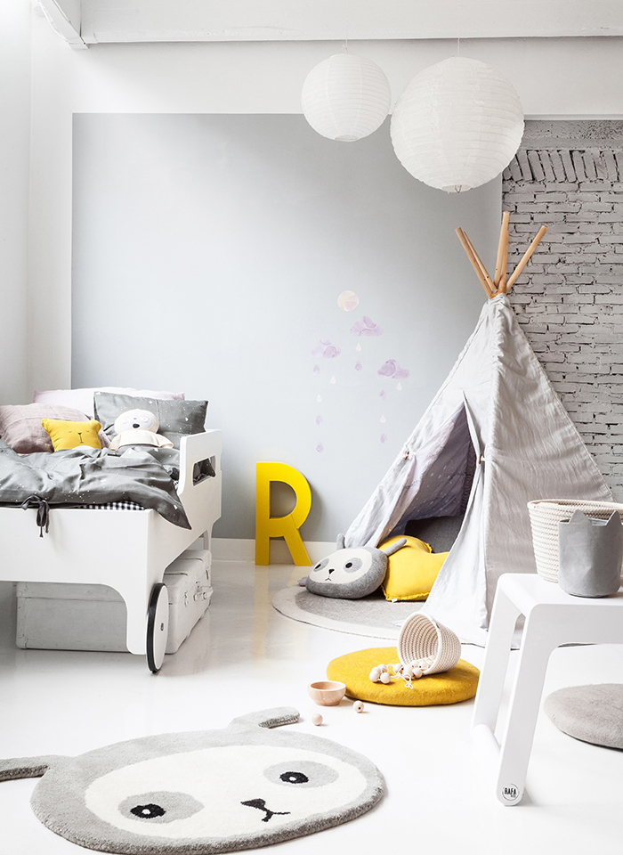 Great modern gender neutral bedroom yellow accent and the exposed brick wall