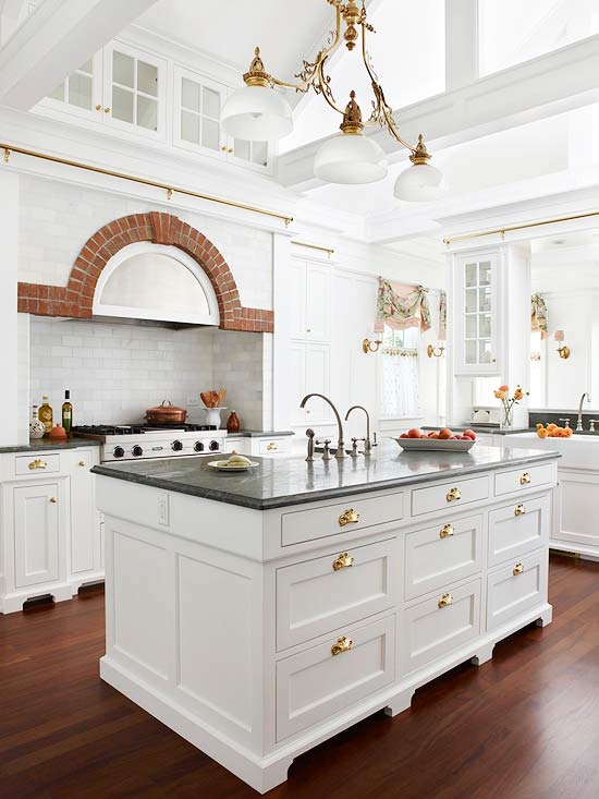White Kitchen with 3 pendant lights hang from intricate gold framework